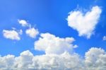 Blue Sky With Hearts Shape Clouds. Beauty Natural Background Stock Photo