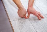 Handyman Laying Down Laminate Flooring Boards Stock Photo