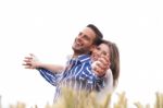 Couple Enjoying The Breeze In The Park Stock Photo