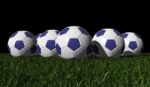 Blue Soccer Balls On A Green Grass Stock Photo