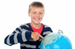 Smiling Young Boy With Globe Stock Photo