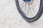 Bicycle Wheel With Flat Tyre On The Concrete Road Stock Photo