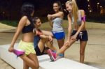 Group Of Girls Doing Stretching At Night Stock Photo