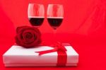 St Valentine's Setting With Present And Red Wine Stock Photo