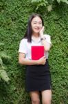 Thai Adult Student University Beautiful Girl Reading Red Book Stock Photo