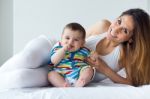 Mother And Baby Playing And Smiling At Home Stock Photo