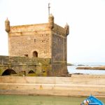 Boat And Sea In Africa Morocco Old Castle Brown Brick  Sky Stock Photo