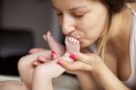 Kissing Baby Feet Stock Photo