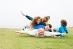 Happy Family Playing At Park Stock Photo