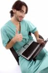 Surgeon On Laptop With Thumbs Up Stock Photo