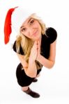 Praying Female Wearing Santa Hat Stock Photo