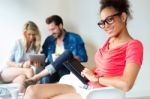 Young Business Woman Using Her Tablet, In The Background The Bus Stock Photo