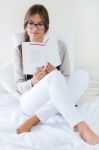 Lying Beautiful Woman Reading Book At Home Stock Photo