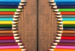 Multicolored Pencils On A Background Of Dark Wood Tables Stock Photo