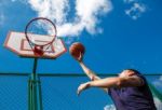 Young Man Playing Basketball Stock Photo