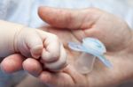 Mother's Hand Baby's Hand And His First Dummy Stock Photo