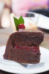 Piece Of Chocolate Cake On White Plate Stock Photo