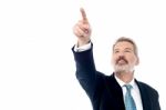 Happy Businessman Pointing At Copyspace Stock Photo