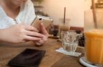 Woman Using Phone In Cafe Stock Photo