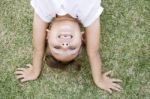 Girl Doing Cartwheel In The Grass Stock Photo