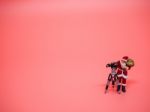 Miniature Santa Claus With Vdo Camera On Pink Background. Christ Stock Photo