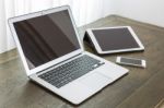 Laptop With Tablet And Smart Phone On Table Stock Photo