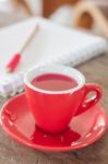 Red Mug With Open Notebook Stock Photo