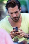 Young Man Using His Mobile Phone In The Street Stock Photo