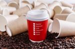 Red Paper Coffee Cup With Paper Cups Background Stock Photo