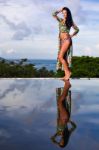 Pretty Brunette Model In Bikini Posing At The Pool Stock Photo