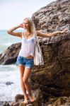 Beautiful Young Blonde Woman Posing Outdoor At The Rocky Sea Sho Stock Photo