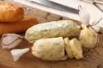 Baguette With Herb Butter And Rosemary Thyme On Rustic Wooden Background Stock Photo