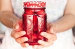 Woman's Hand Holding Red Glass Stock Photo