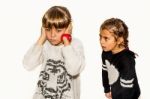 Eight Year Old Girl Being Angry And Shouting At Her Sister. Isolated On White Stock Photo