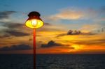 Lamp With Sunset In The Sea Stock Photo