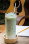 Matcha Tea With Milk On Creative Work Table Stock Photo