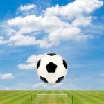 Soccer Ball With Soccer Field Against  Blue Sky Background Stock Photo