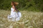 young Woman running In Meadow Stock Photo