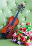 Violin With Artificial Roses Flower Bouquet Stock Photo