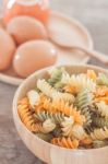 Fusili Pasta In Wooden Plate With Eggs Stock Photo