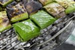 Closeup Fish In Banana Leaf On The Grill Stock Photo