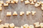 Happy Alphabet Biscuit On Wooden Table Stock Photo