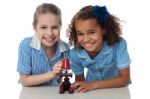 Joyous Young School Girls With Microscope Stock Photo