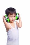 Young Asian Boy In A White Singlet Wearing Earmuffs Stock Photo