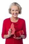 Senior Woman With Heart Shaped Gift Box Stock Photo