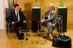 Businessperson Talking In Lobby Stock Photo