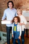 Little Girl With Parents Posing Casually Stock Photo