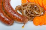 Beef Sausages Cooked On Iron Skillet Stock Photo