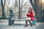 Girl Using A Smartphone In A City Park Sitting On A Bench. Vintage Tone Stock Photo