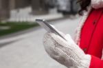 Woman In Red Coat With Smartphone In Hands Going Through The Cit Stock Photo